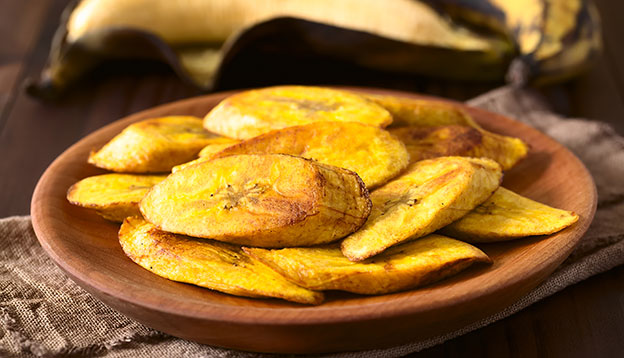 Fried slices of ripe plantains, traditional and popular snack and accompaniment in Central and Northern South America, photographed with natural light