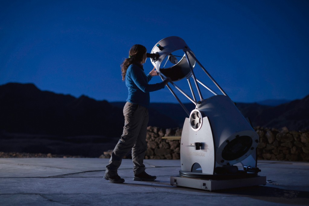Girl with telescope in Atacama Desert
