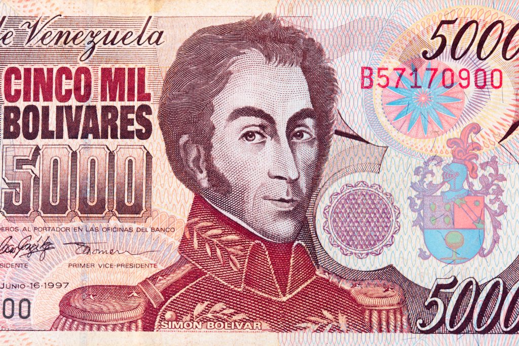 Detail of old invalid Venezuelan 5000 Bolivar banknote with the portrait of Simon Bolivar. Photo Credit: Shutterstock