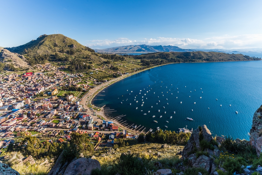 aerial view over the city copacobana and lake titicaca with mountains in the background