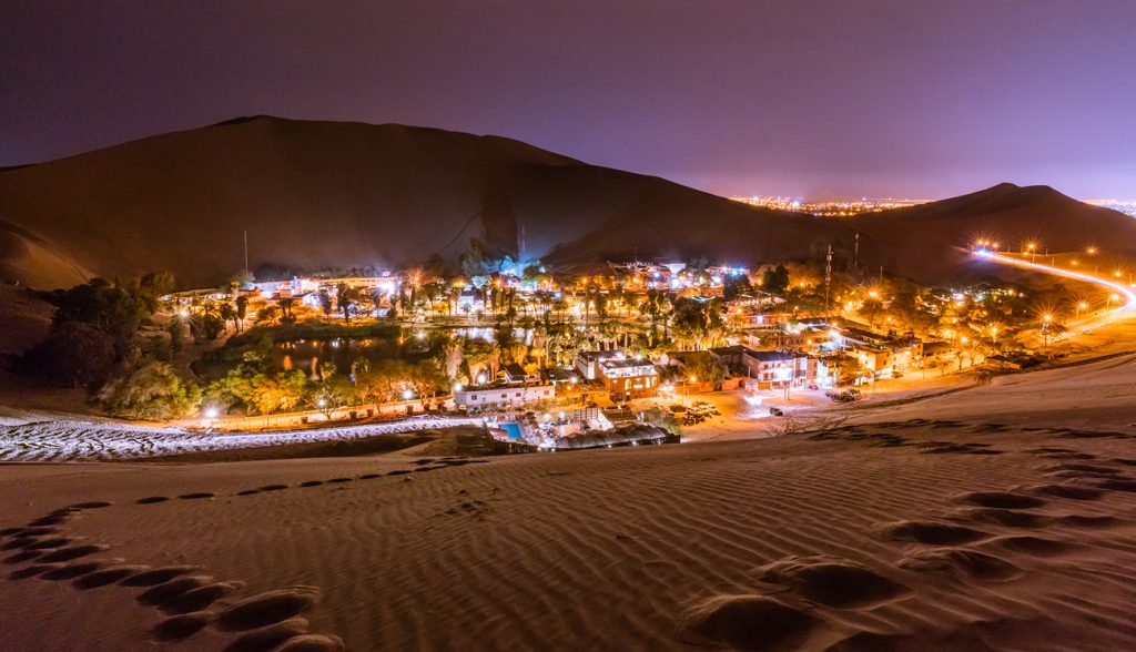 Climbing up the sand dunes here in Huacachina/Peru in order to take a nice landscape picture of this Oasis -