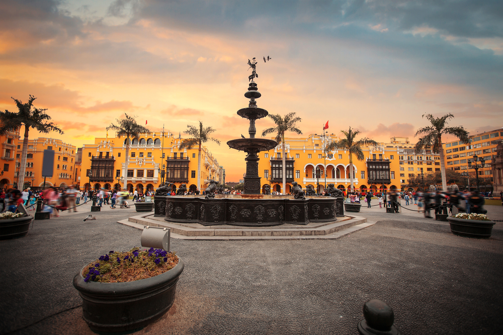 square in lima with big fountain and surrounded by yellow houses
