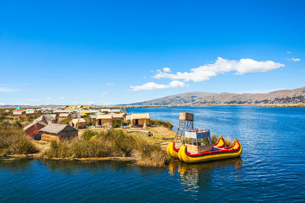 reed boats on lake titicaca with reed sheds in background