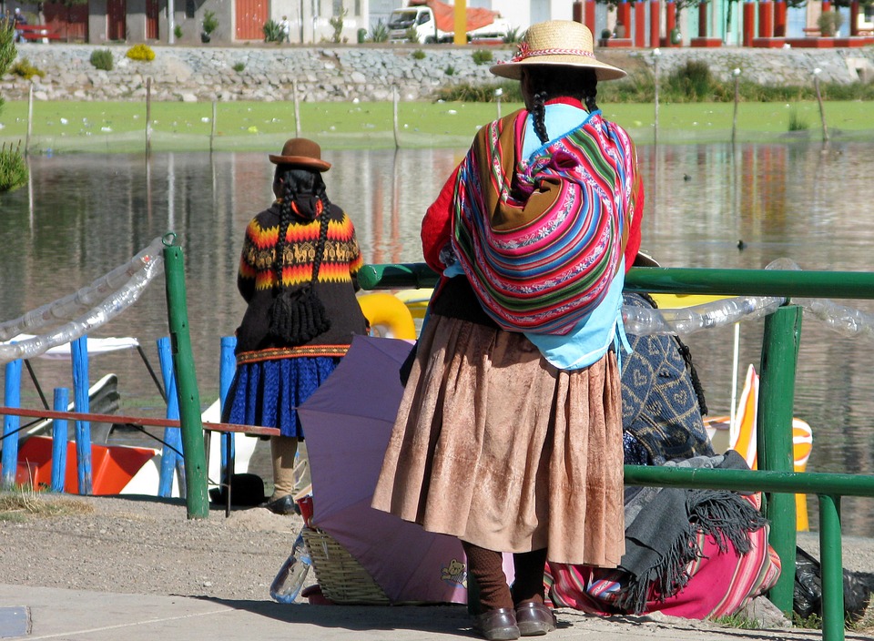 local peruvian woman waiting next to river