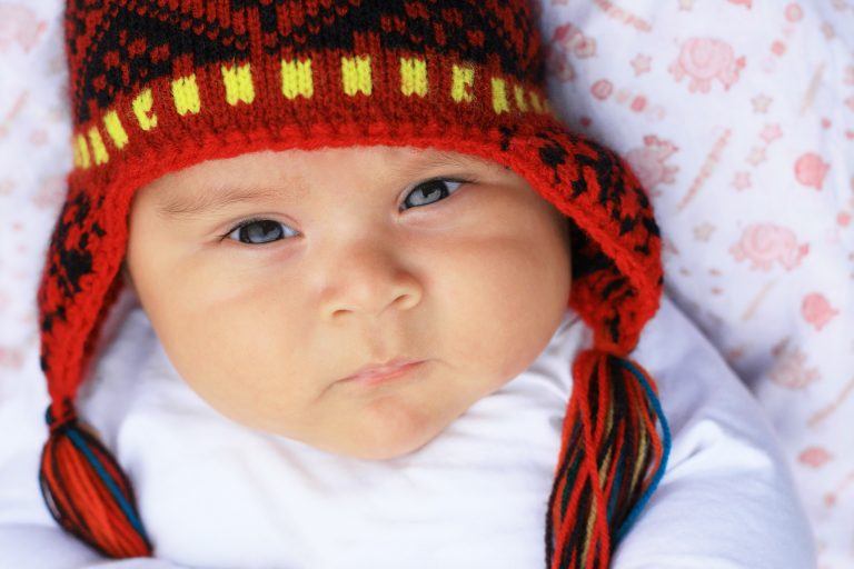 Serious latin baby boy in warm hat - peruvian credit shutterstock